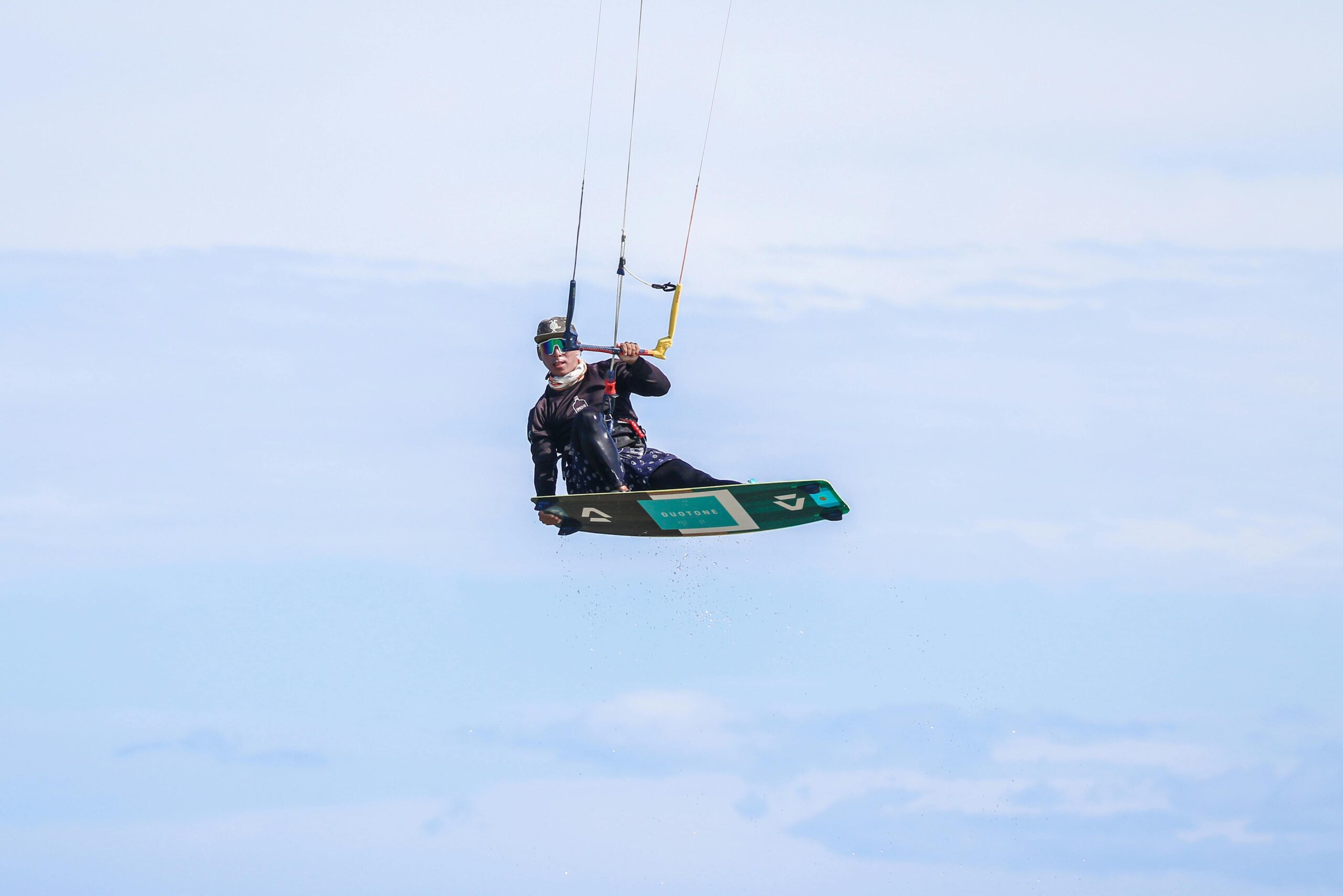 Kitesurfer in Egypt jump an hold his board